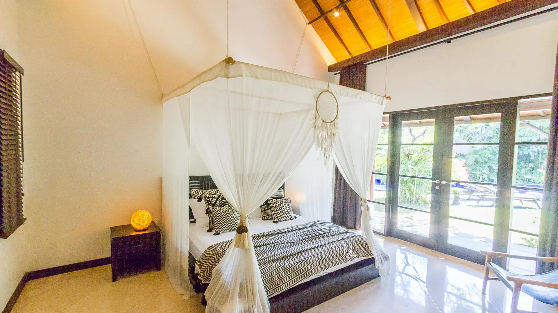 villa yumi bedroom with king sized bed and mosquito net